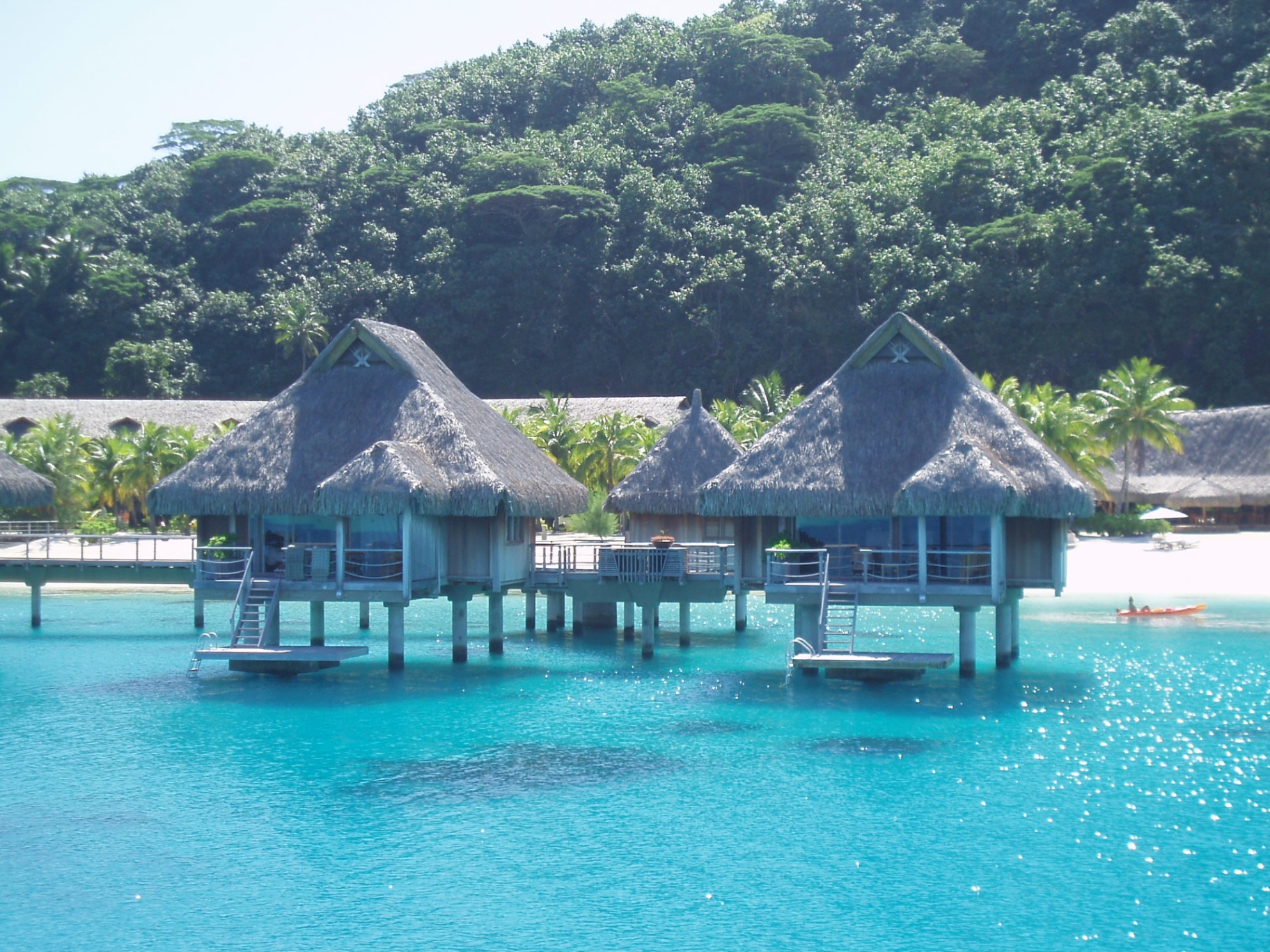 Overwater bungalows over turquoise lagoon